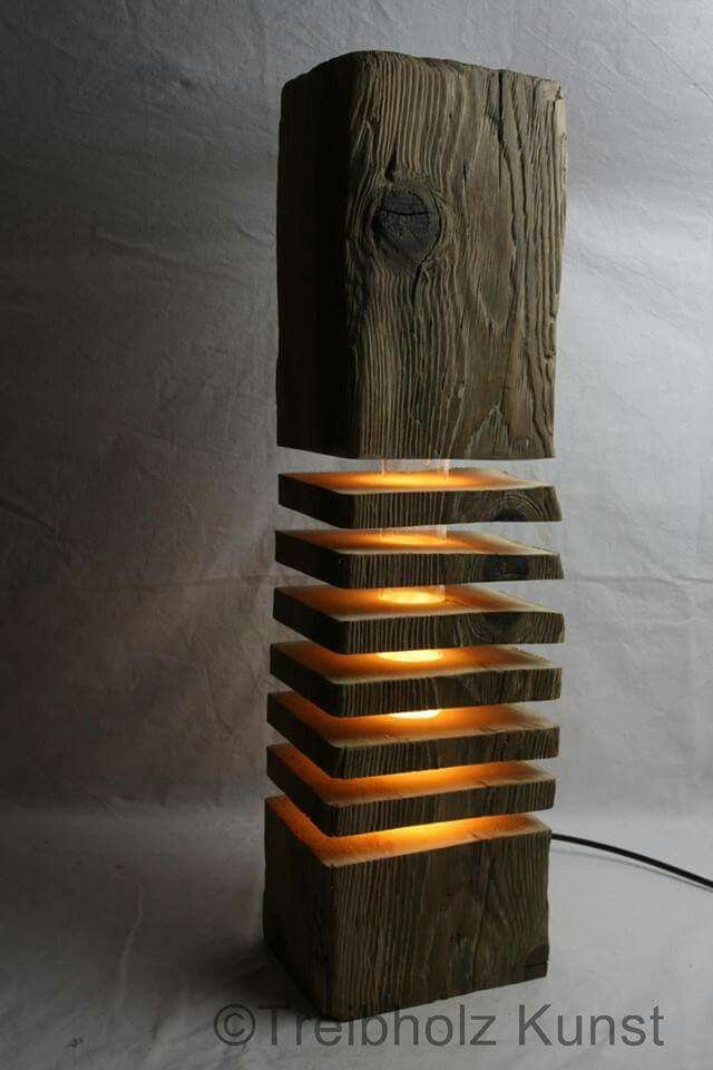 a lamp made out of wood and lit up with some lights on top of it