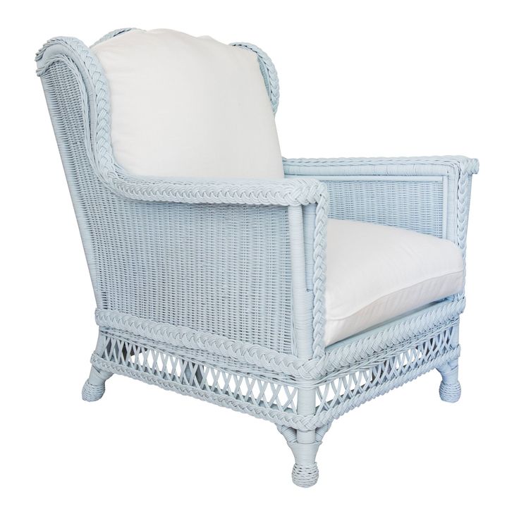 a blue wicker chair with white pillows