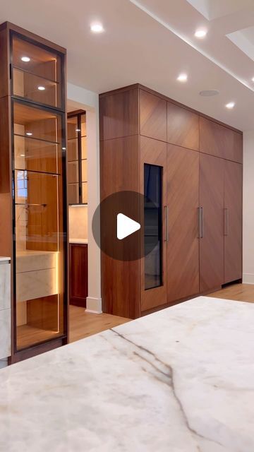 a large room with wooden cabinets and marble counter tops