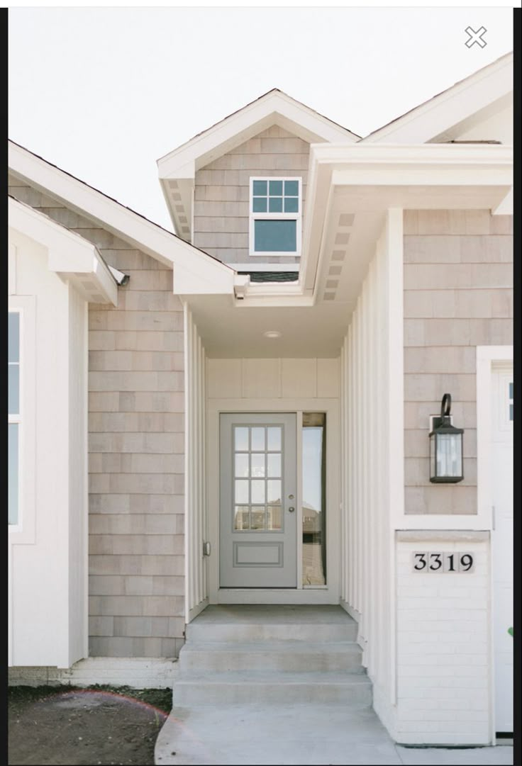 a house with two garages and a light on the front door that says 5319