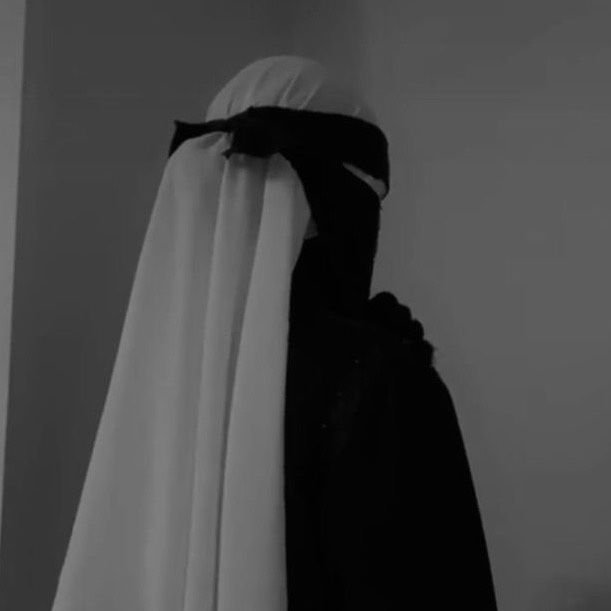 black and white photo of nun with veil on head