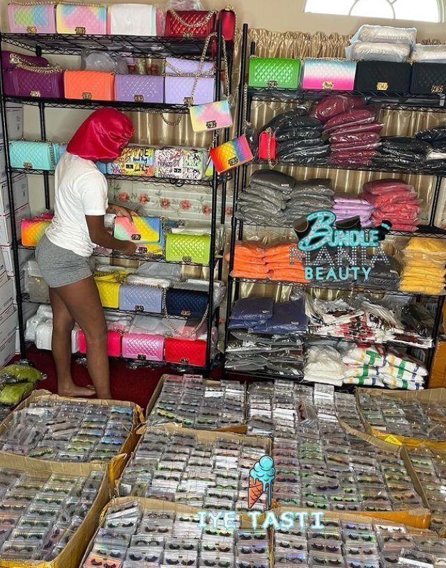 there is a woman that is looking at some items in the store and it looks like she's trying to sell them