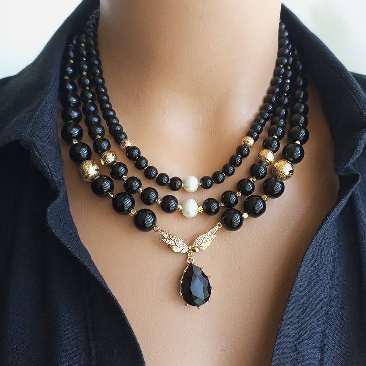 A true statement piece that exudes elegance and sophistication, our elegant Onyx Multi-Strand Black Beaded Necklace consists of numerous sparkling onyx beads and zircon bird wing pendants, carefully handcrafted and meticulously assembled to create a stunning visual effect. Shiny black onyx beads, known for their grounding and protective properties, add a mystical touch to this elegant boho accessory. MATERIALS: Our Onyx MultiStrand Beaded Necklace is created using high quality black onyx beads k Stone Bead Jewelry, Black Bead Necklace, Onyx Necklace, Boho Accessories, Onyx Bead, Beaded Accessories, Necklace Boho, Necklace Black, Bead Jewellery