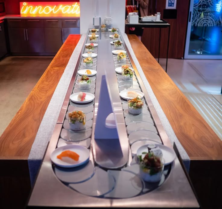 a long table topped with plates and bowls filled with food