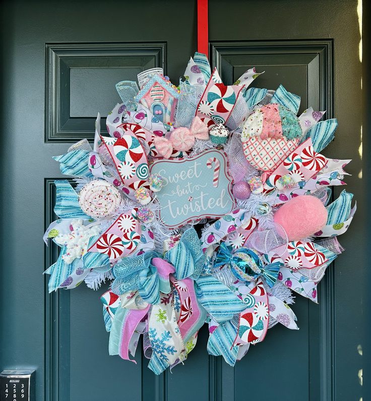 a wreath is hanging on the front door decorated with candy canes and candies