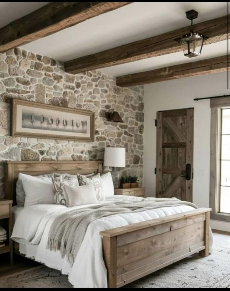 a bedroom with stone walls and white bedding