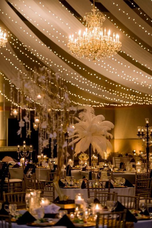 the ceiling is decorated with lights and chandeliers for an elegant wedding or reception