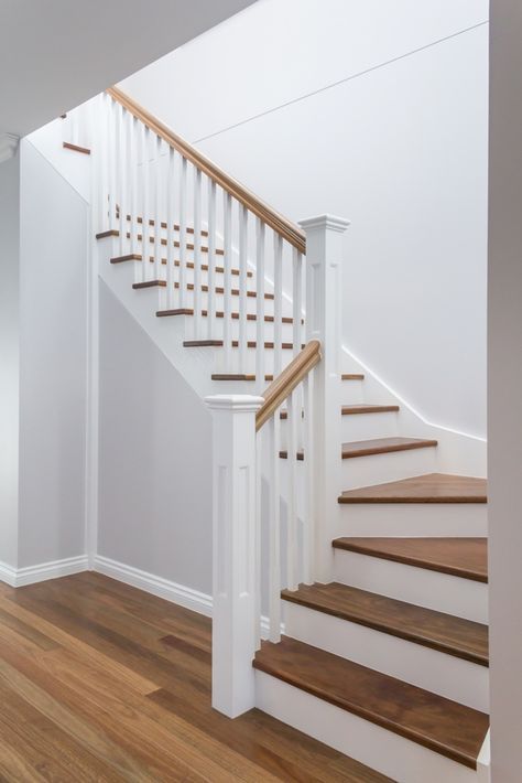 an empty room with stairs and hard wood flooring