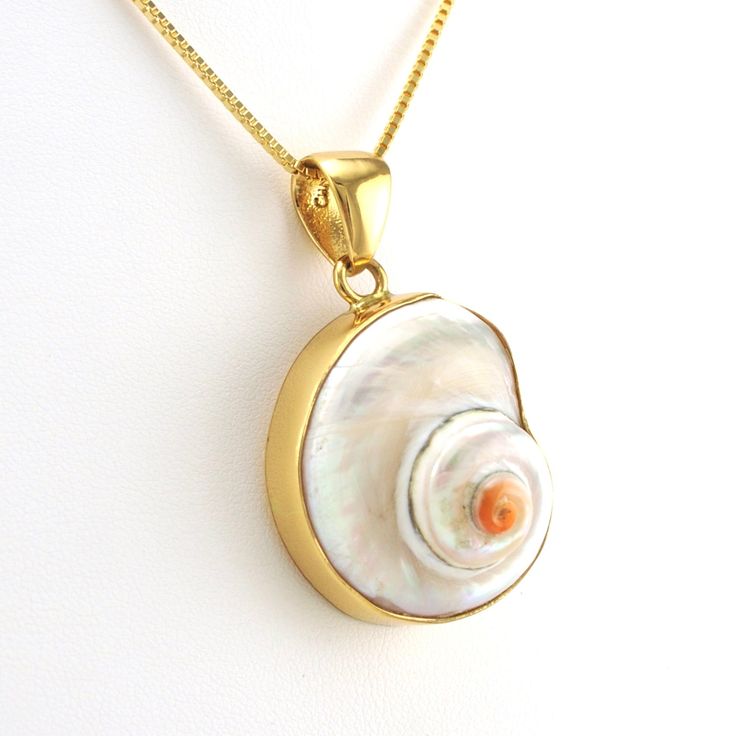 This real cinnerus sea shell is set in a gold tone alchemía setting. Sea shell pendant is 1 3/4 inches long and 7/8 inch wide and is sold separate from the 18k gold fill 1.2mm box chain shown. Alchemía is a blend of base metals that have the look of 18k gold. Style Number: 9179 Metal: Alchemía Gemstone: Genuine Cinnerus Shell Dimensions: 1 3/4 inches long and 7/8 inch wide Handmade in Mexico Mother Of Pearl Shell Pendant As Gift, Spiritual Shell Necklace Gift, Spiritual Gold Shell-shaped Jewelry, Spiritual Gold Shell Jewelry, Unique Gold Shell Necklace Gift, Unique Gold Shell Necklace As Gift, Unique Gold Shell Necklace For Gift, Shell Necklace With Large Pendant, Gold Nickel-free Shell As Gift