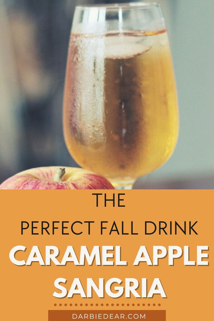 A wine class filled with caramel colored caramel apple sangria and a beautiful red apple sitting beside it. Evening Fall Wedding, Fall Sangria For A Crowd, Carmel Apple Sangria Recipes, Carmel Apple Sangria Easy, Harvest Sangria Recipe, Fall Alcoholic Drinks For A Party Large, Caramel Apple Sangria Recipes, Fall Sangria Recipes Easy, Apple Wine Sangria