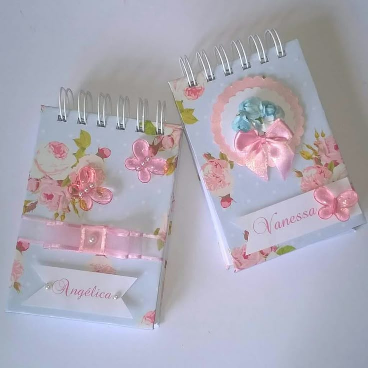 two notebooks decorated with flowers and ribbons