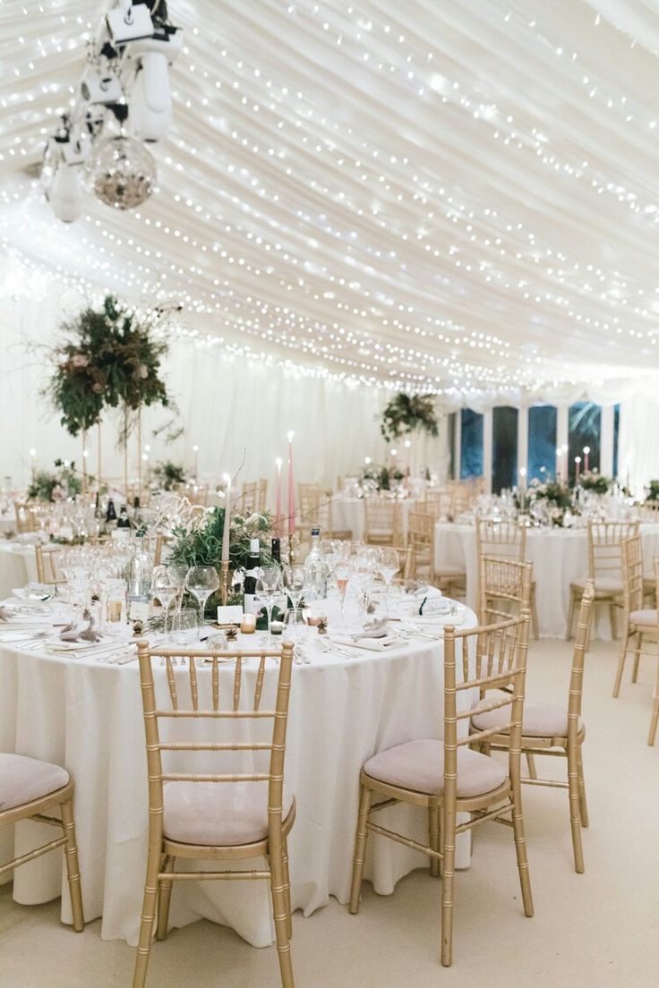 the tables are set with white linens and pink flowers