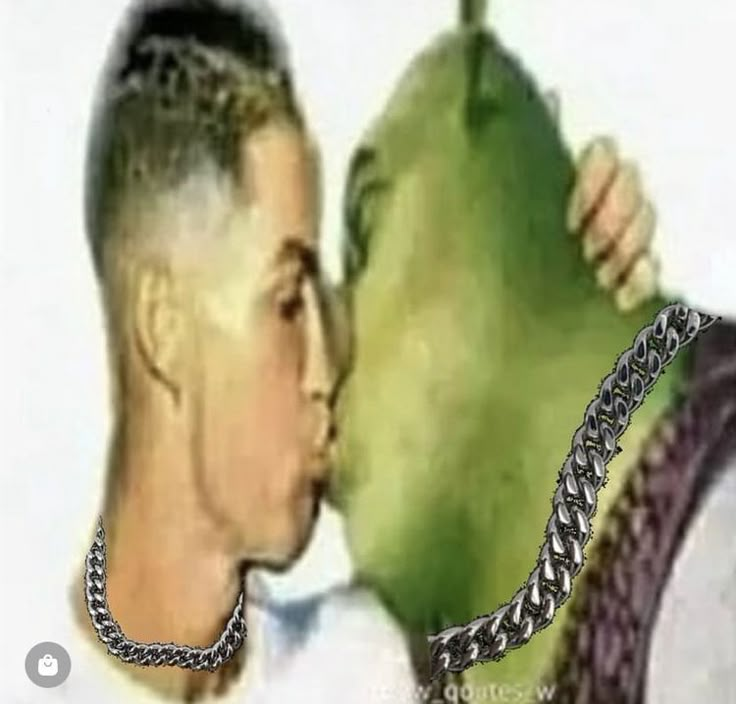 a man kissing a woman on the cheek with a chain around his neck in front of him