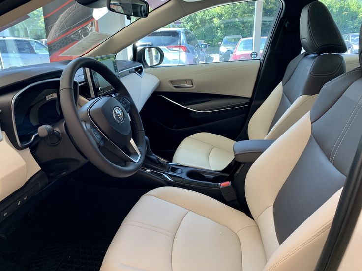 the interior of a car with white leather seats