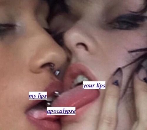 a close up of two people kissing each other with their noses covered in piercings