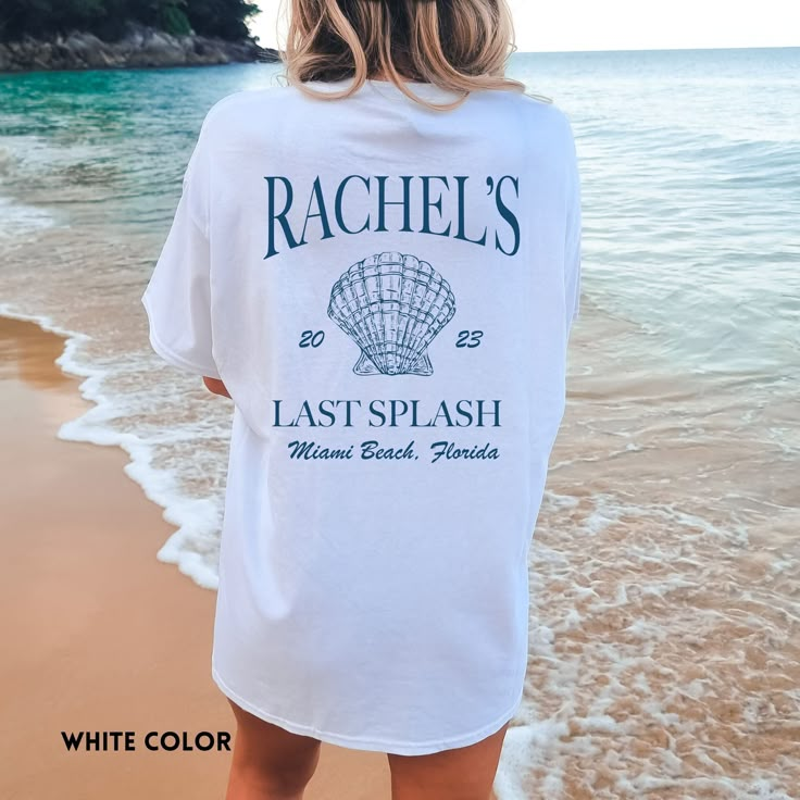 a woman standing on the beach wearing a white t - shirt that says rachel's last splash