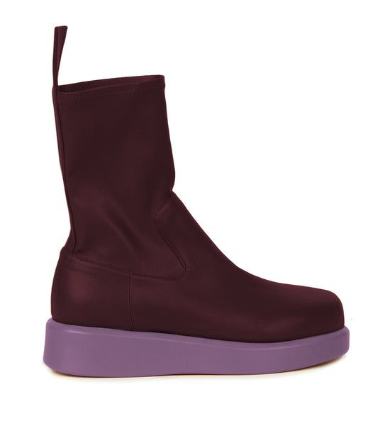 Our continued collaboration with the master shoemaker Gia Borghini featured in the edgiest selection for Fall 2022! A new novelty style introduced to our collection this season, the Baia boots, with a fashion-forward appeal are one of the most unique boots that instantly stylize one's look. Crafted in a beautiful soft stretch calf leather in burgundy that enables comfort and mobility further elevated with a smooth lilac platform. A Silvia Tcherassi play with contrasts is thoughtfully referenced with the contrast of the upper and sole of the shoe. Gia Borghini, Unique Boots, Fall 2022, End Of Season Sale, The Master, Pre Fall, First Look, Calf Leather, Fashion Forward