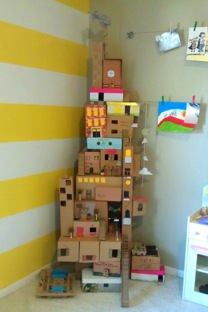 cardboard boxes stacked on top of each other in a room with yellow and white striped walls