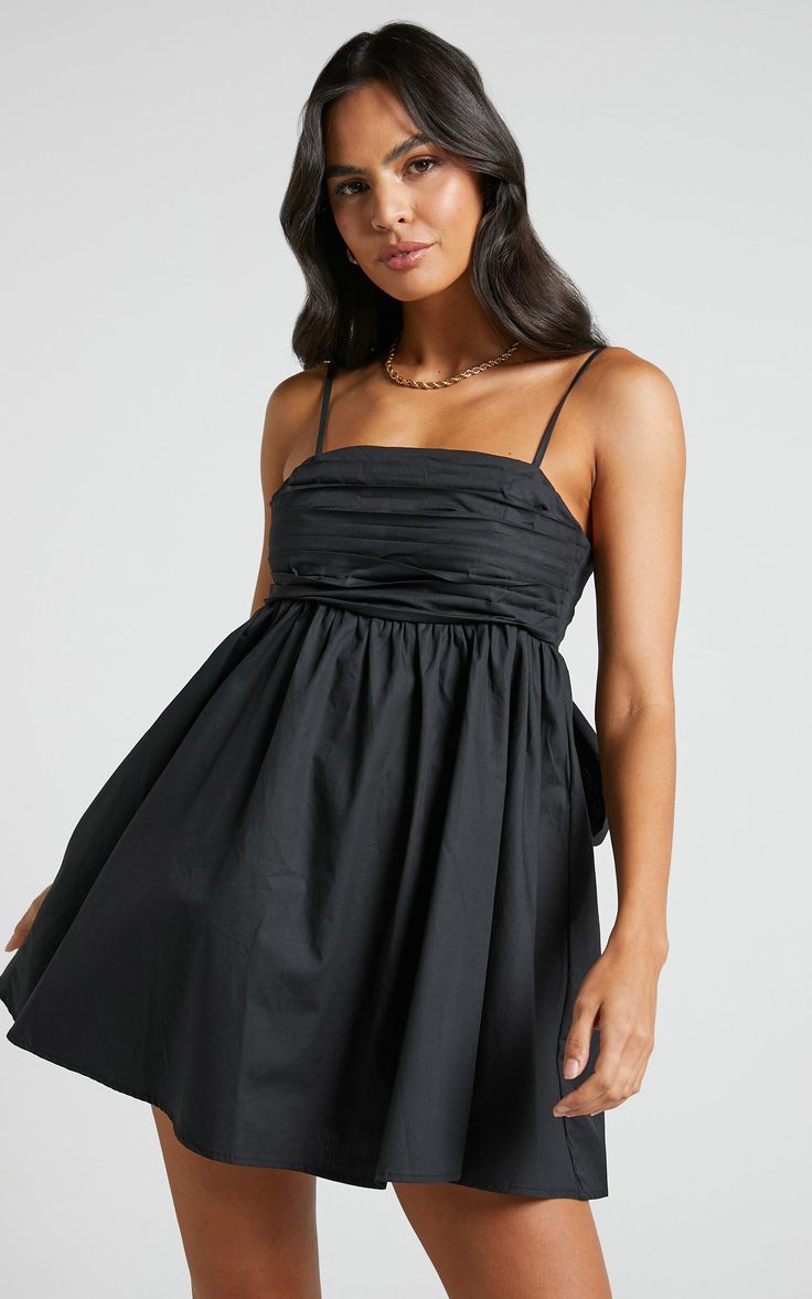 Clover Mini Dress - Back Bow Babydoll Dress in Black | Showpo USA Chic Black Mini Dress With Bow Tie Back, Chic Mini Dress With Bow Straps, Chic Black Dresses With Bow Tie Back, Chic Black Dress With Bow Tie Back, Black Mini Dress With Bow Straps For Date Night, Black Dress With Bow Straps For Date Night, Flirty Black Dress With Bow, Flirty Black Mini Dress With Bow, Casual Mini Dress With Bow