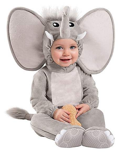 a baby wearing an elephant costume sitting on the ground