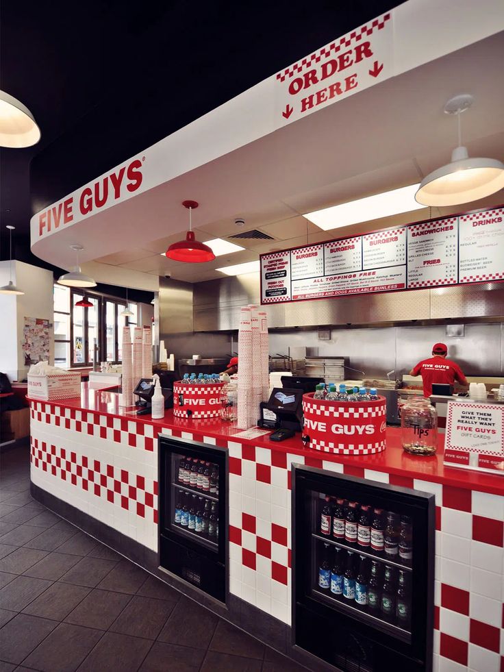 the inside of a fast food restaurant with red and white checkered counters