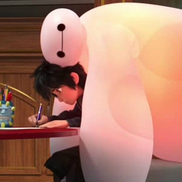 a person sitting at a desk writing on a piece of paper in front of a giant white bear