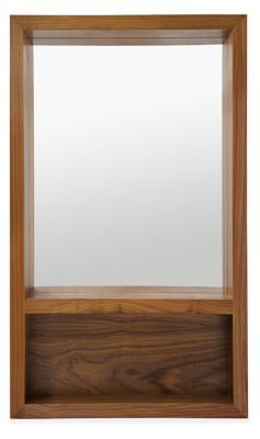 an empty wooden shelf with a mirror on it's top and bottom section, against a white background