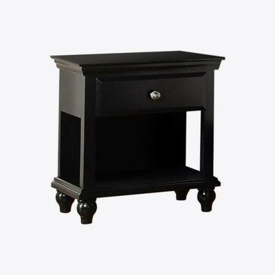 a black night stand with one drawer open