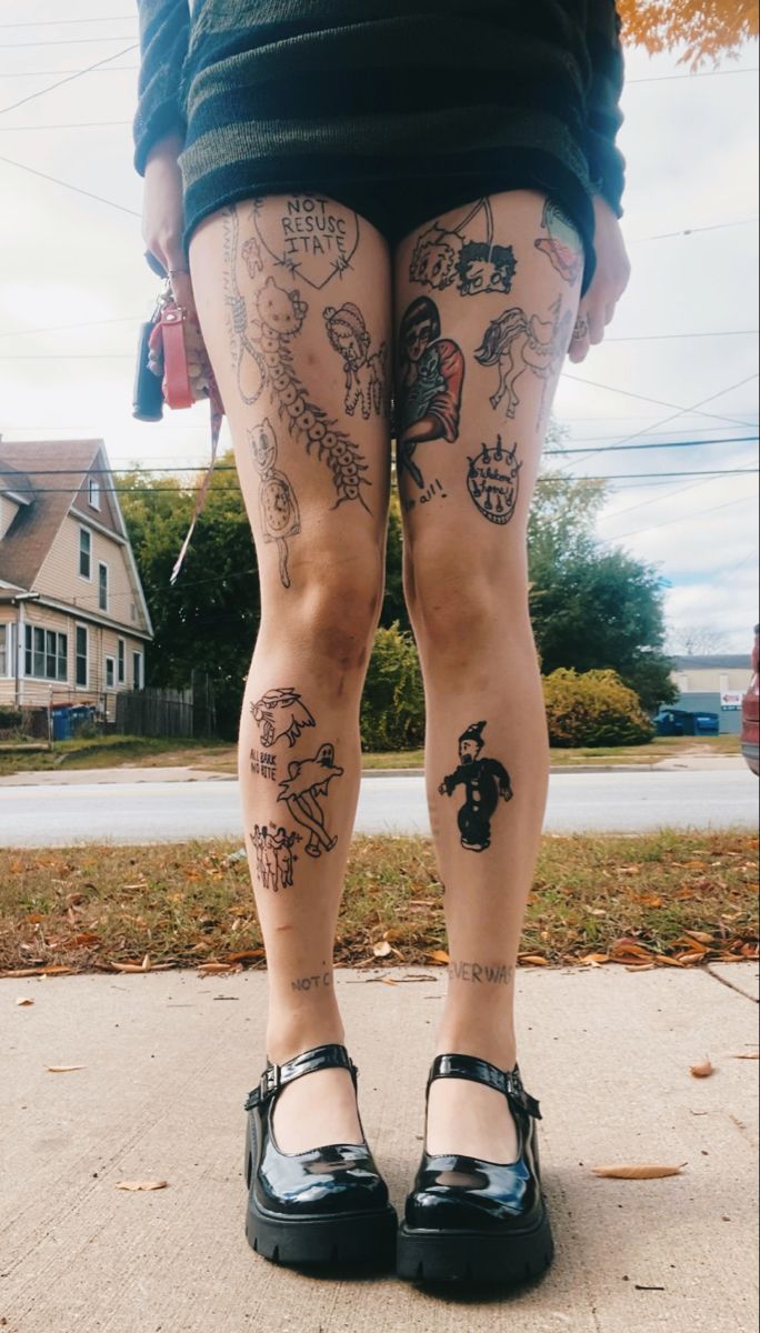 a woman's legs with tattoos on them