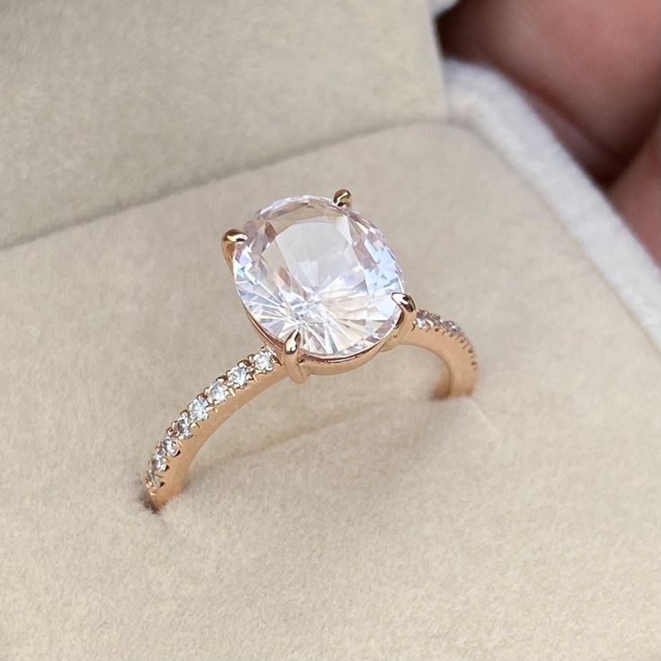 a close up of a ring with a diamond on it's side in a box