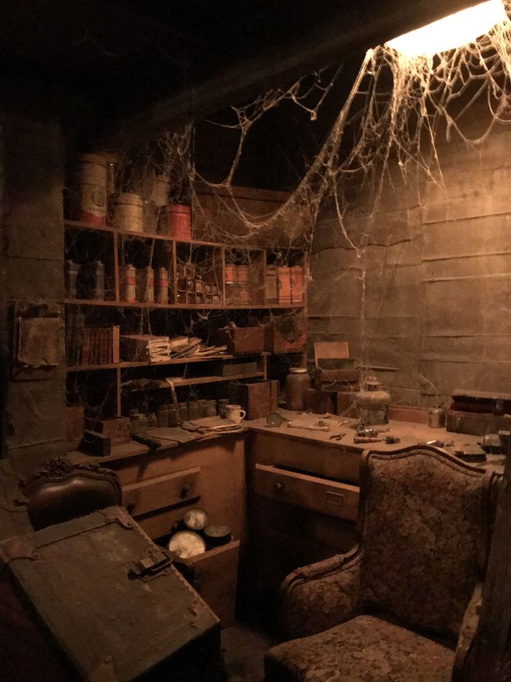 an old fashioned desk and chair in a room with lots of wires hanging from the ceiling