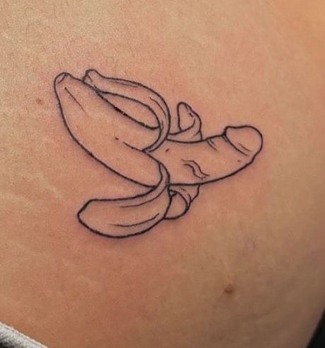 a banana tattoo on the back of a woman's stomach