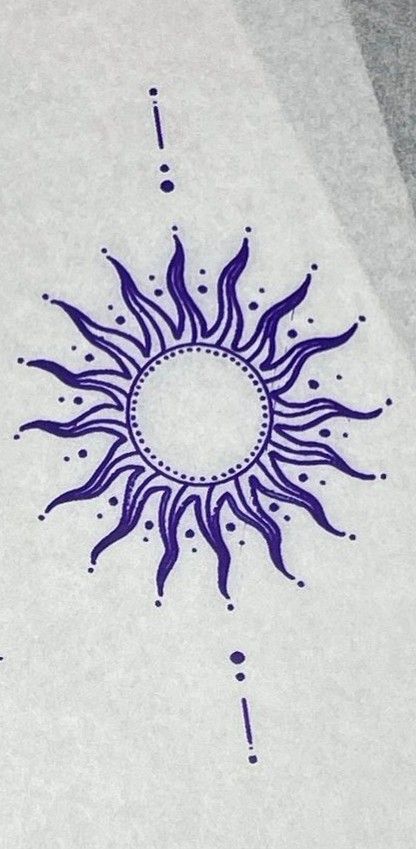 a drawing of a sun is shown on the ground with blue ink and white paper