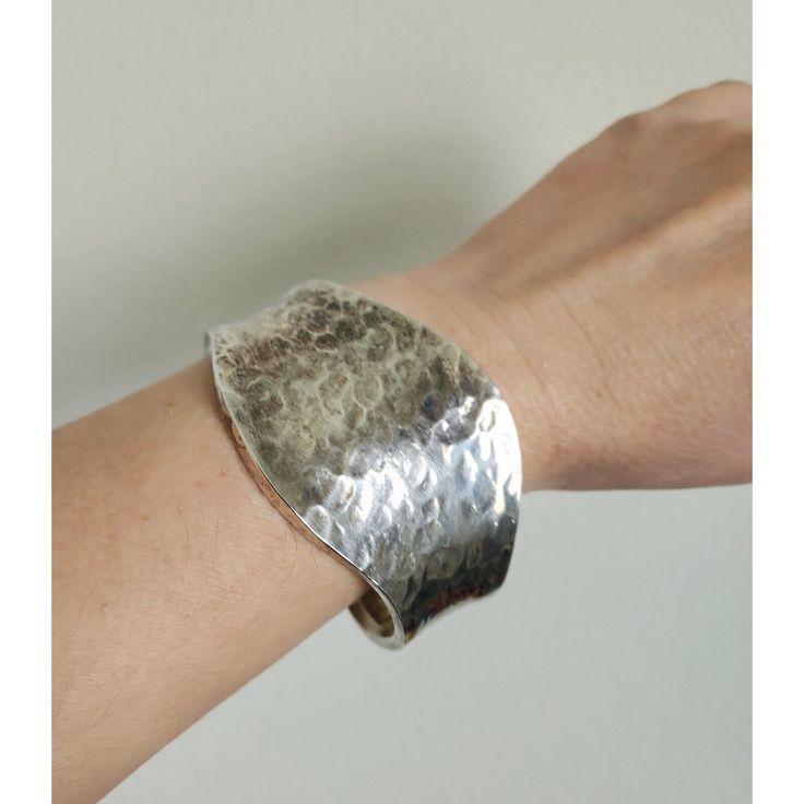 Discover A Unique Piece Of Artisan Craftsmanship With This Stunning Vintage Sterling Silver Mexican Hammered Cuff Bracelet. Weighing A Substantial 35.6 Grams, This Bracelet Showcases The Intricate Artistry Of Traditional Mexican Silversmithing. Features: Material: Sterling Silver Weight: 35.6 Grams Width: 2 Inches (Front, Widest Area) Hallmarks: Stamped 925 And Mex, Signifying Genuine Quality And Mexican Origin Design: Hammered Texture For A Rustic Yet Sophisticated Look Condition: Excellent Vin Elegant Hand-cast Cuff Jewelry, Elegant Hand Cast Cuff Bracelet, Elegant Hammered Cuff Bangle, Handmade Artisan Cuff Bracelet, Handmade Artisan Bangle, Handmade Cuff Bracelet Bangle For Formal Occasions, Handmade Elegant Cuff Bracelet, Handmade Cuff Bracelet For Wedding, Handmade Wedding Cuff Bracelet