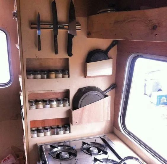 the inside of a camper with several cooking utensils