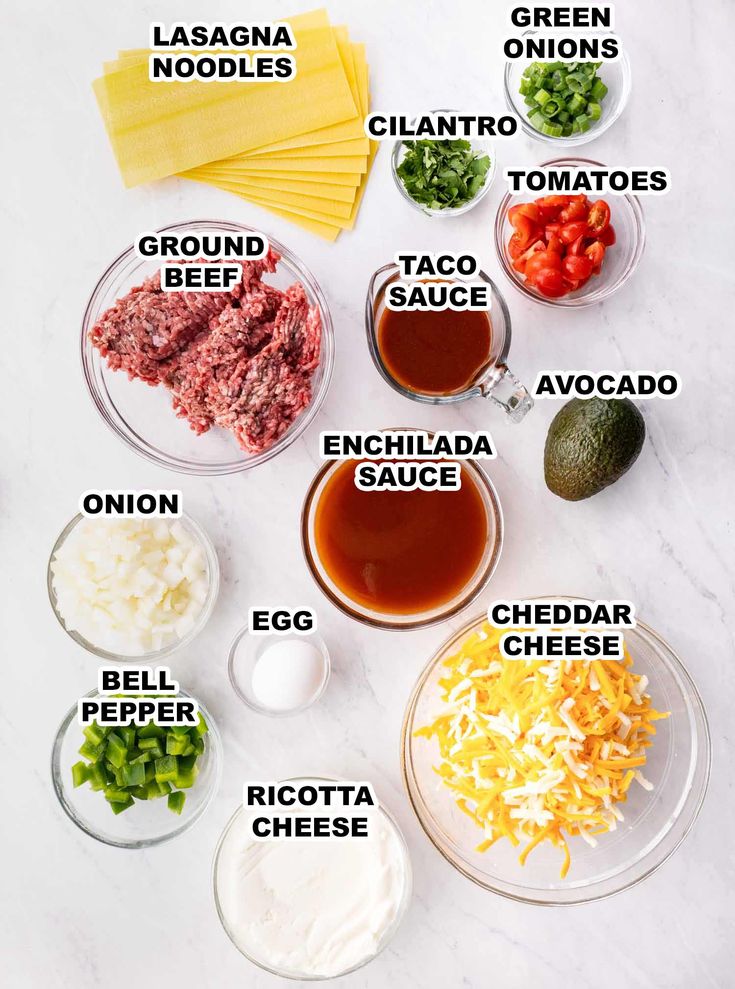 the ingredients to make an enchilada recipe are shown on a white surface