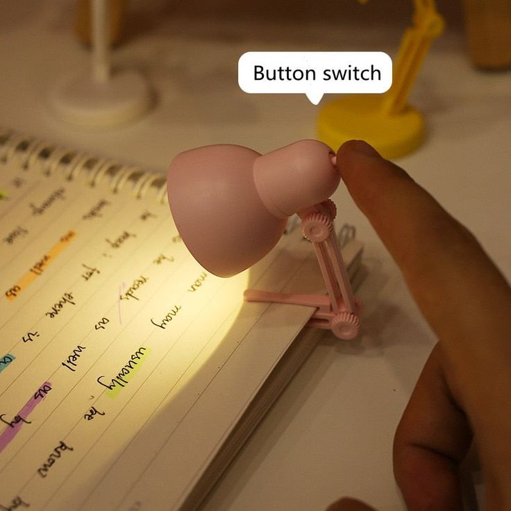 a hand is pointing at a pink light on a notepad that says switch button