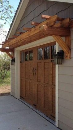 an outside view of a garage with wooden doors