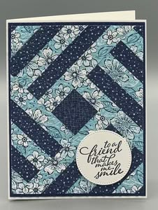 a card with blue and white quilting on it, featuring the words be friends together smile