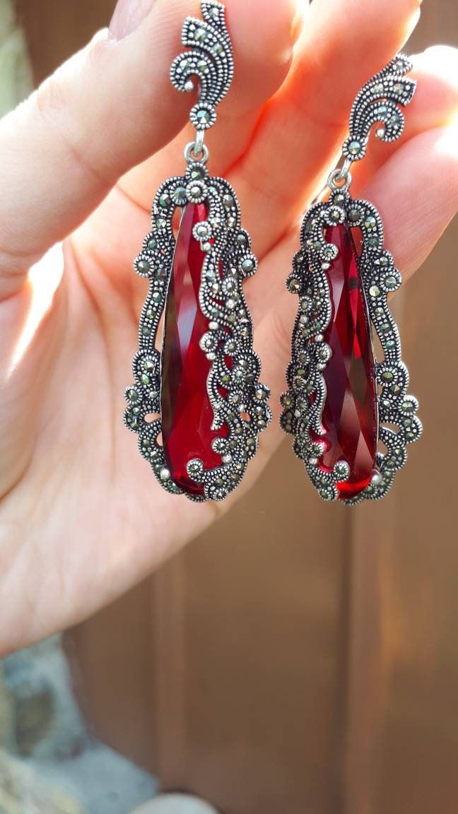 Earrings Weight: 19.5 gram Luxurious Red Long earrings with comfotable Latch Back Large Red Earrings Huge Red Earrings Long Dangle Marcasite Heavy Very Long Red Earrings Luxury Red Jewelry Evening Red Earring Woman Gift Earrings details: Lenght: 6,5cm= 2.6 inches Width : 1,5 cm Weight: 20 grams Ring details: Weight 13,5 grams Size: Any size available Shipping time: Europe 3-4 weeks USA and other countries 3-4 weeks Sometimes 5 weeks depending on the season Marcasite Earrings, Earrings Luxury, Luxury Earrings, Red Jewelry, Ruby Earrings, Earrings Red, Red Earrings, Long Red, Earrings Long