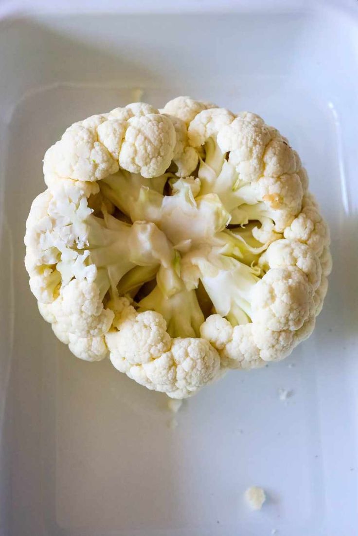 an overhead view of a cauliflower on a white plate