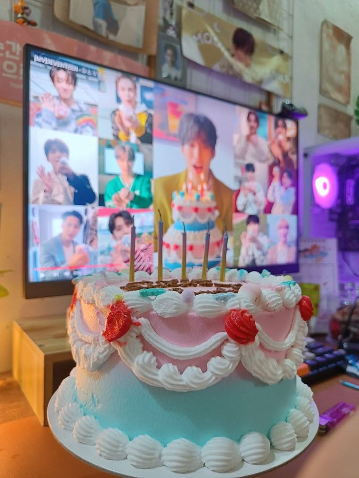 a birthday cake sitting on top of a table in front of a flat screen tv