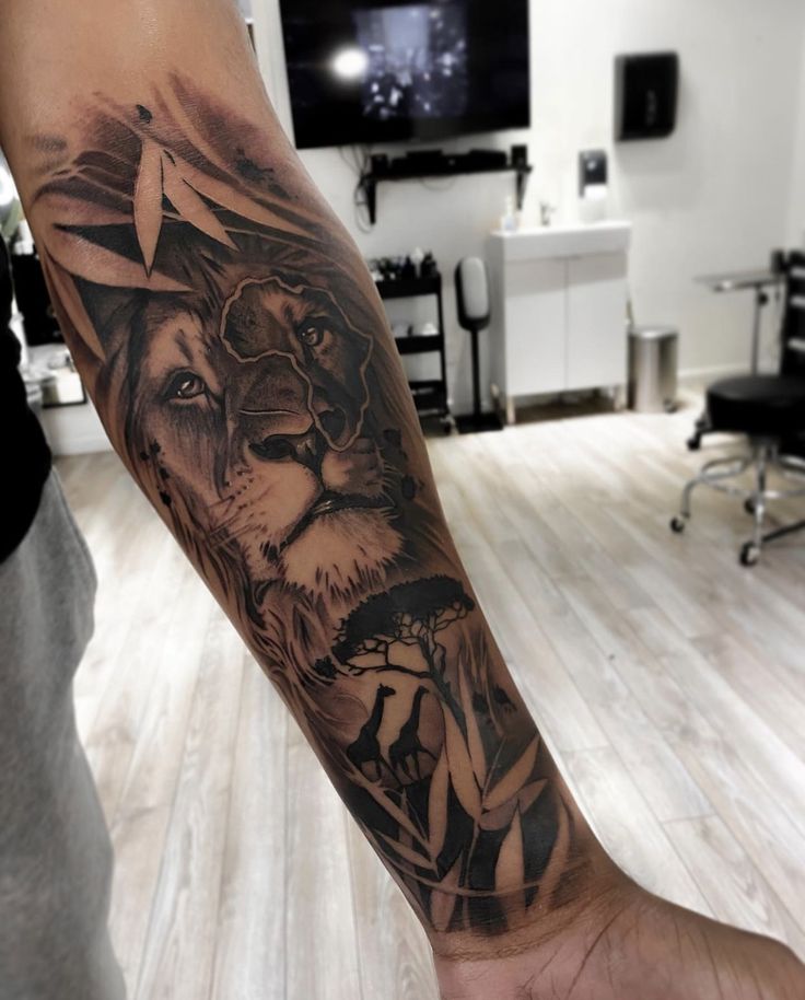 a man's arm with a lion tattoo on it and a star in the middle