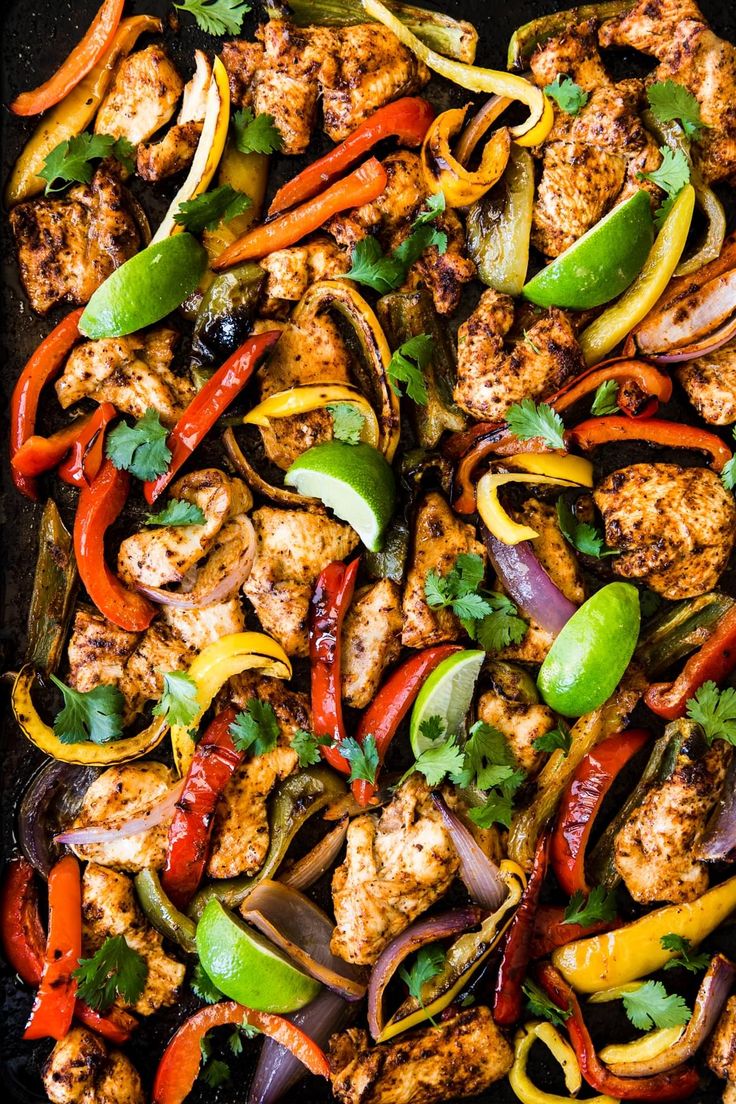 chicken fajita with peppers, onions and cilantro in a skillet