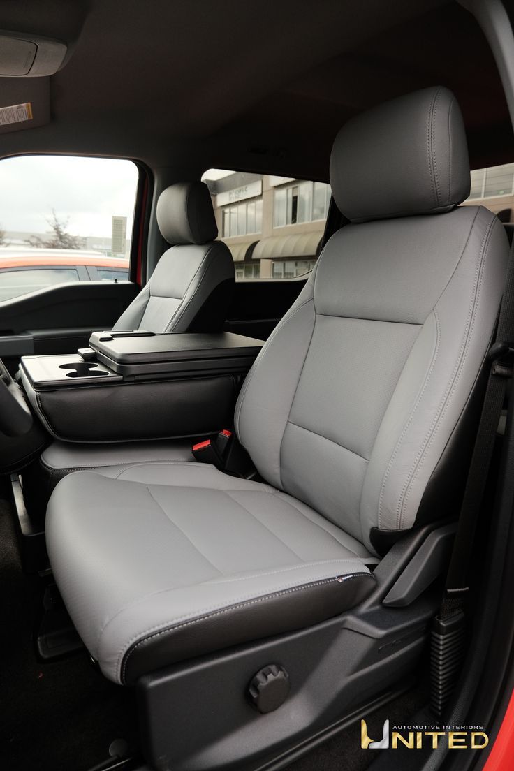 the interior of a truck with grey leather seats