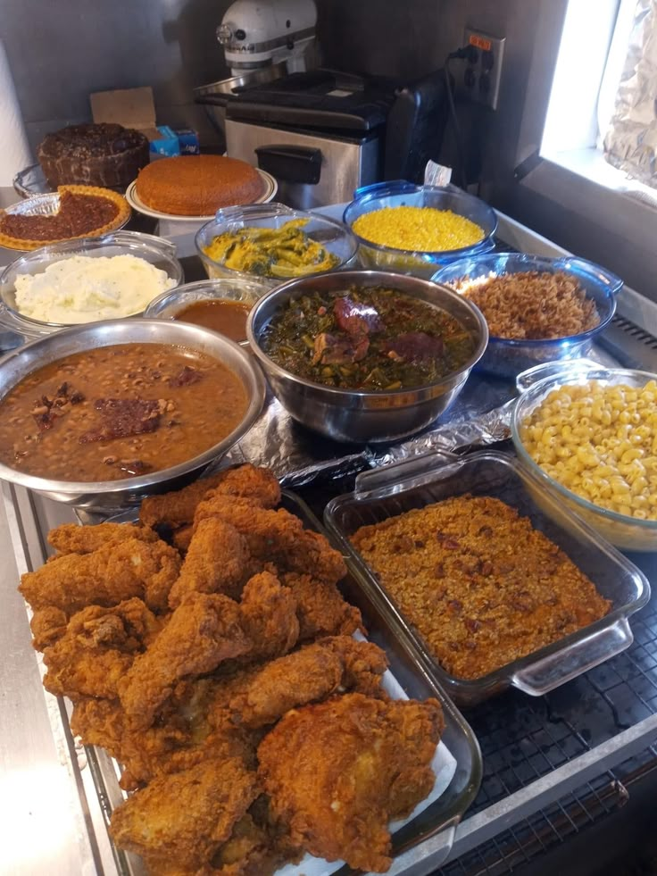 many different types of food are on display in a buffet area, including fried chicken and cornbreads