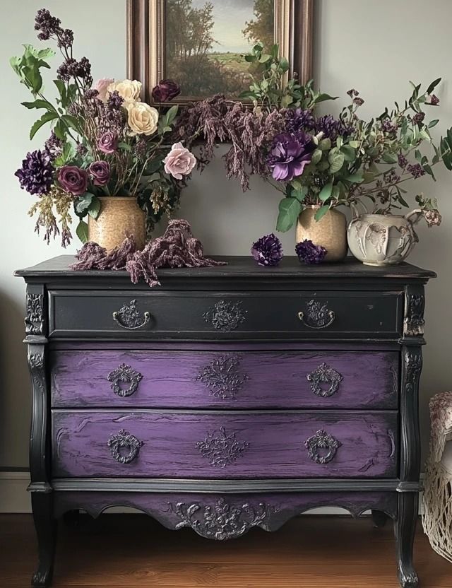 a purple dresser with flowers on top