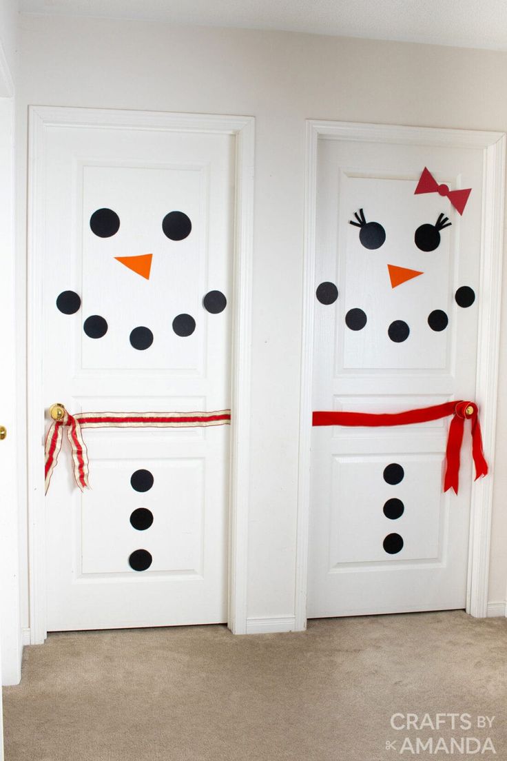 two white doors decorated with black polka dots and red bows, one is snowman