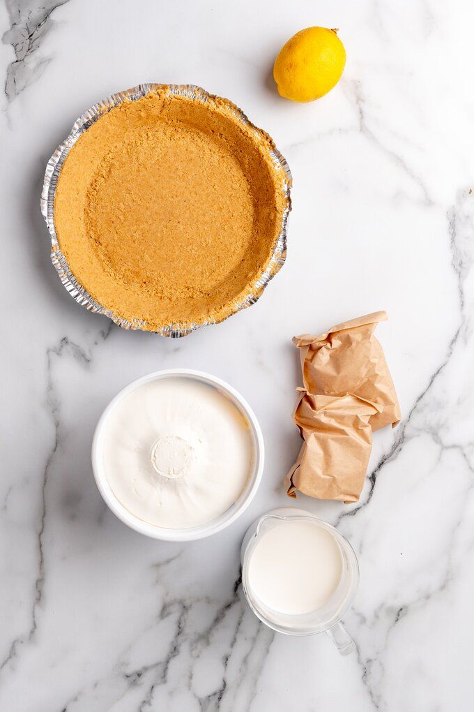 ingredients to make a pie sitting on a marble counter top