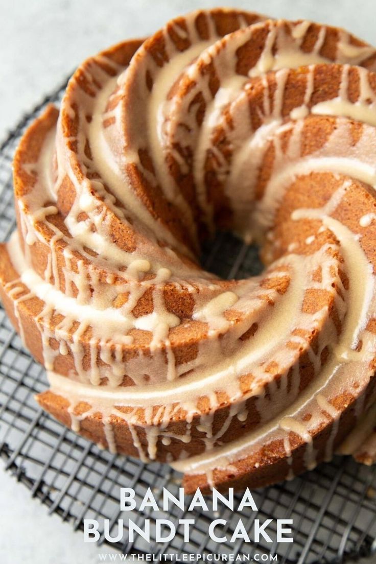 there is a bundt cake with icing on the cooling rack